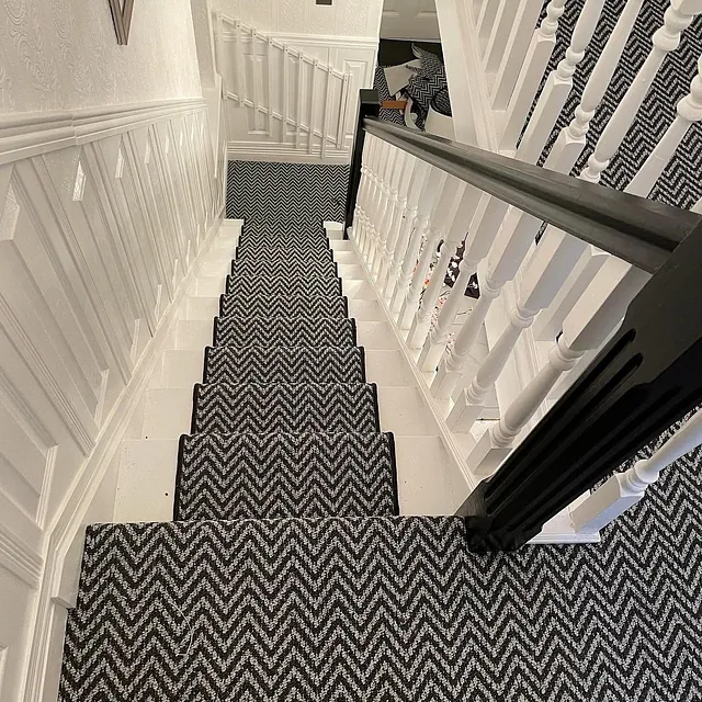 Aztec zig-zag carpet fitted with a runner teamed with a black bind along the edges to finish the look