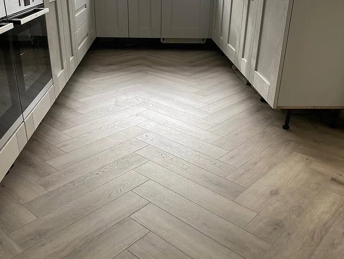 Herringbone laminate sweeping through the ground floor in a stylish silver oak plank
