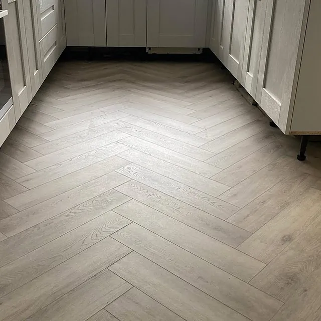 Herringbone laminate sweeping through the ground floor in a stylish silver oak plank
