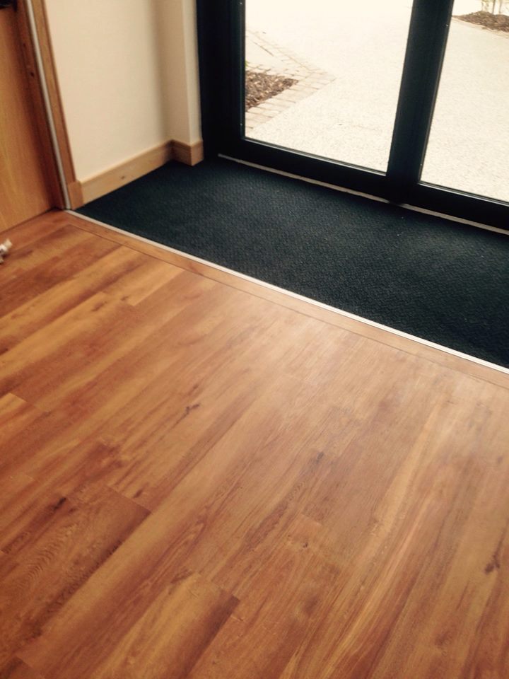 Wooden flooring and entrance carpet