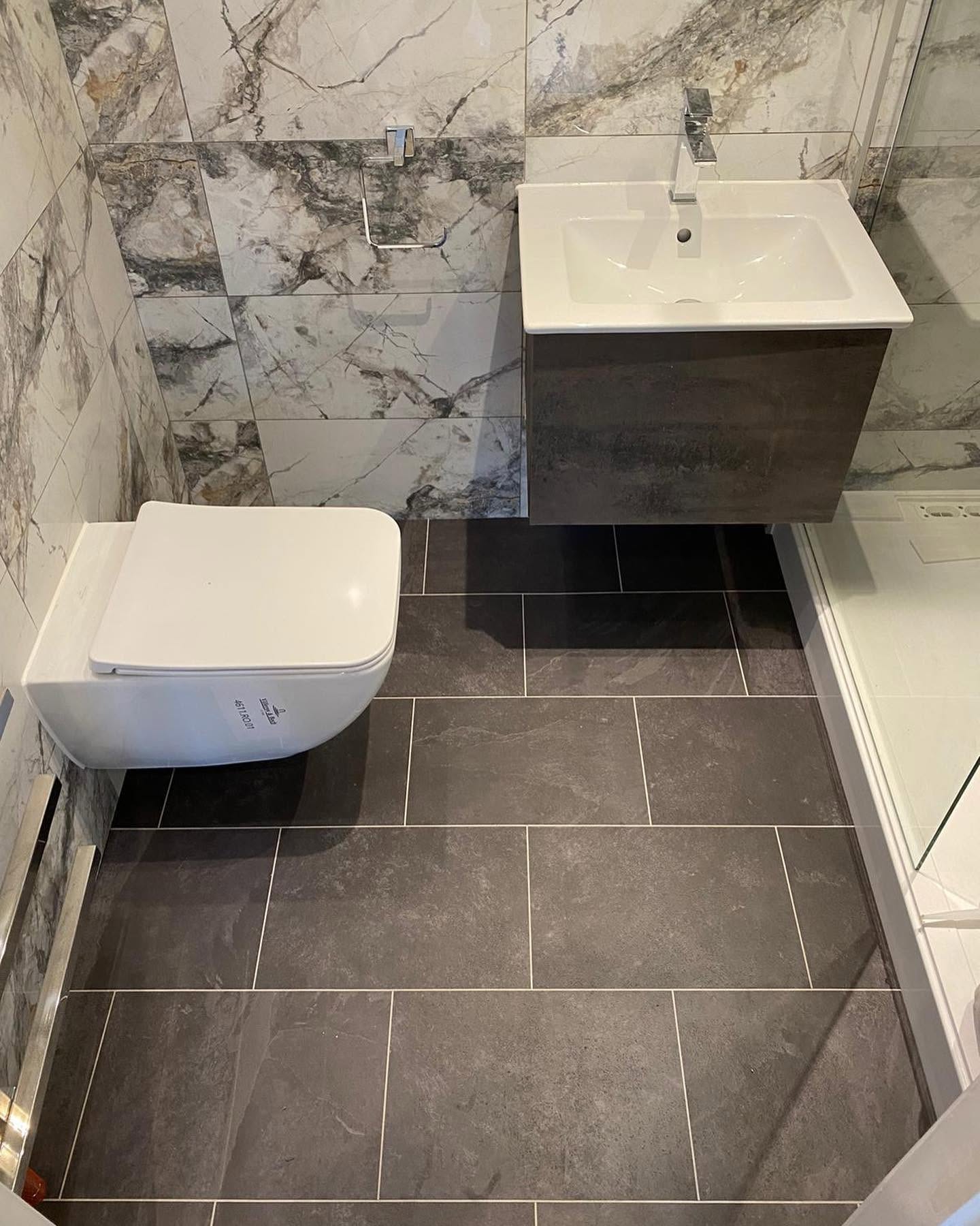 Karndean LVT bathroom project completed in a sleek Black Riven Slate teamed with the DS12 grout line feature strip