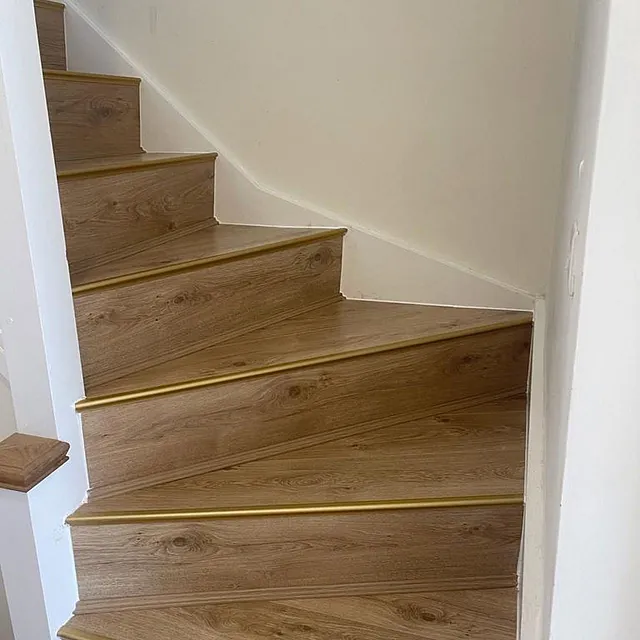 A classic 8mm laminate flooring stair case teamed with brass nosings to finish the look