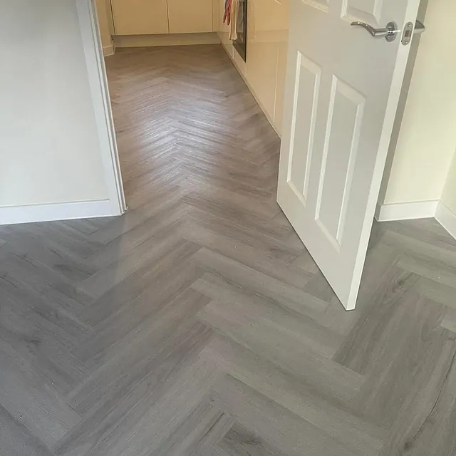 Bonnetto herring bone laminate fitted in Greystone Oak in living room