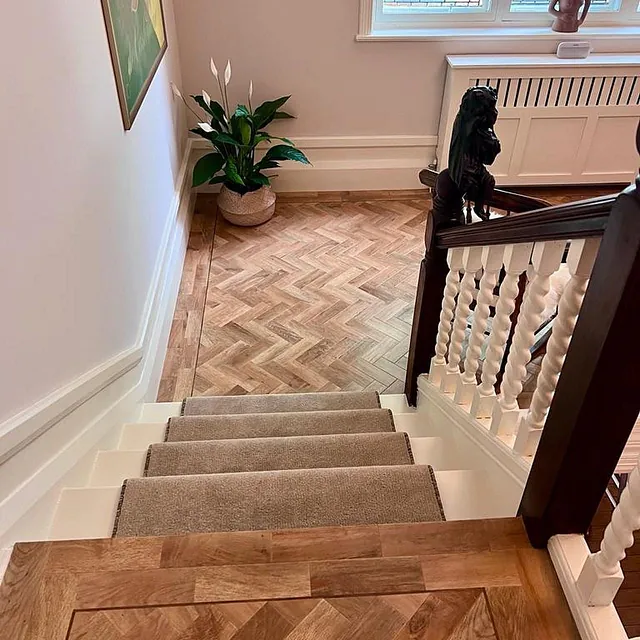 Karndean - Art Select colour Blonde Oak fitted in a classic herringbone design and teamed with a walnut feature strip along the border