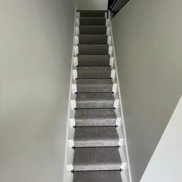 Stain free tweed carpet runner finished with stair rods by our expert fitters