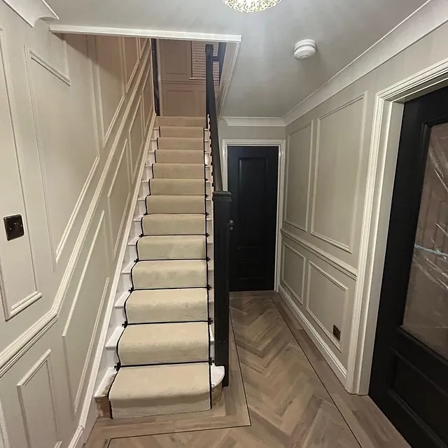 Cream carpet with carpet rods on stairs