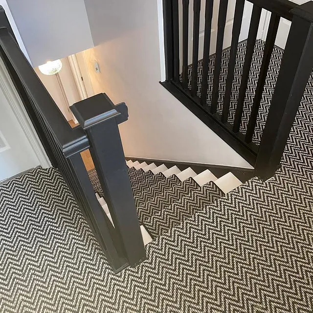 Stairs and landing finished in our premium Aztec heavy domestic carpet black and white stair runner double-bound in sleek black edging